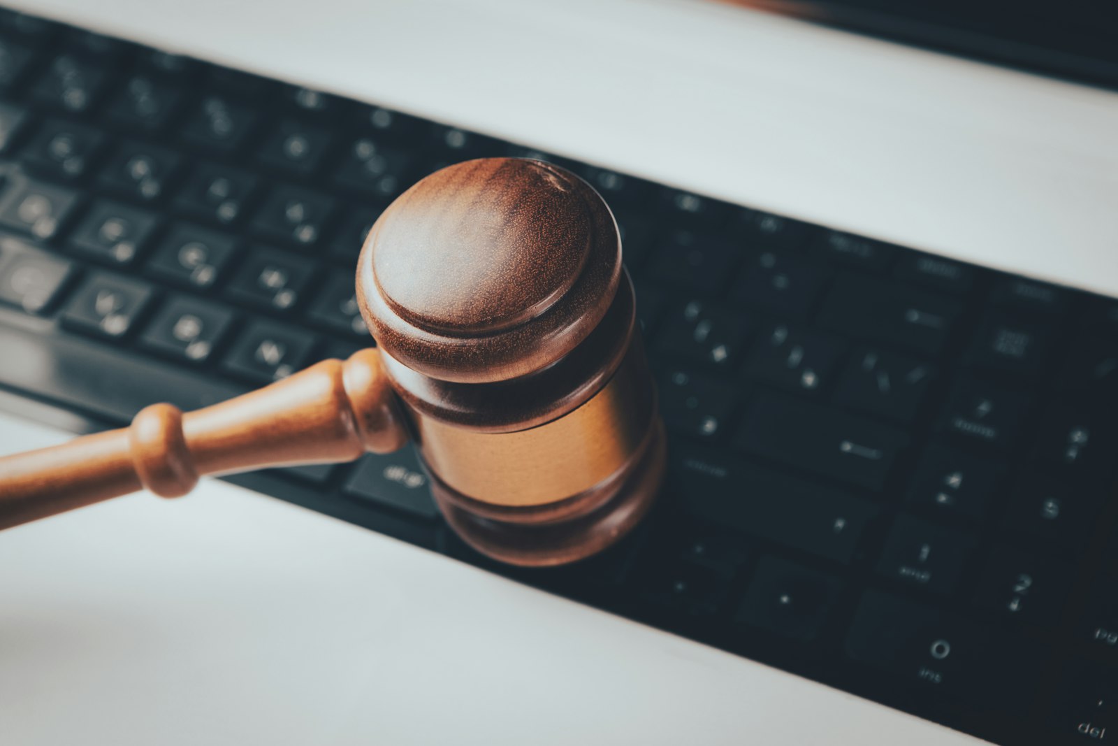 Wooden gavel on top of a computer keyboard